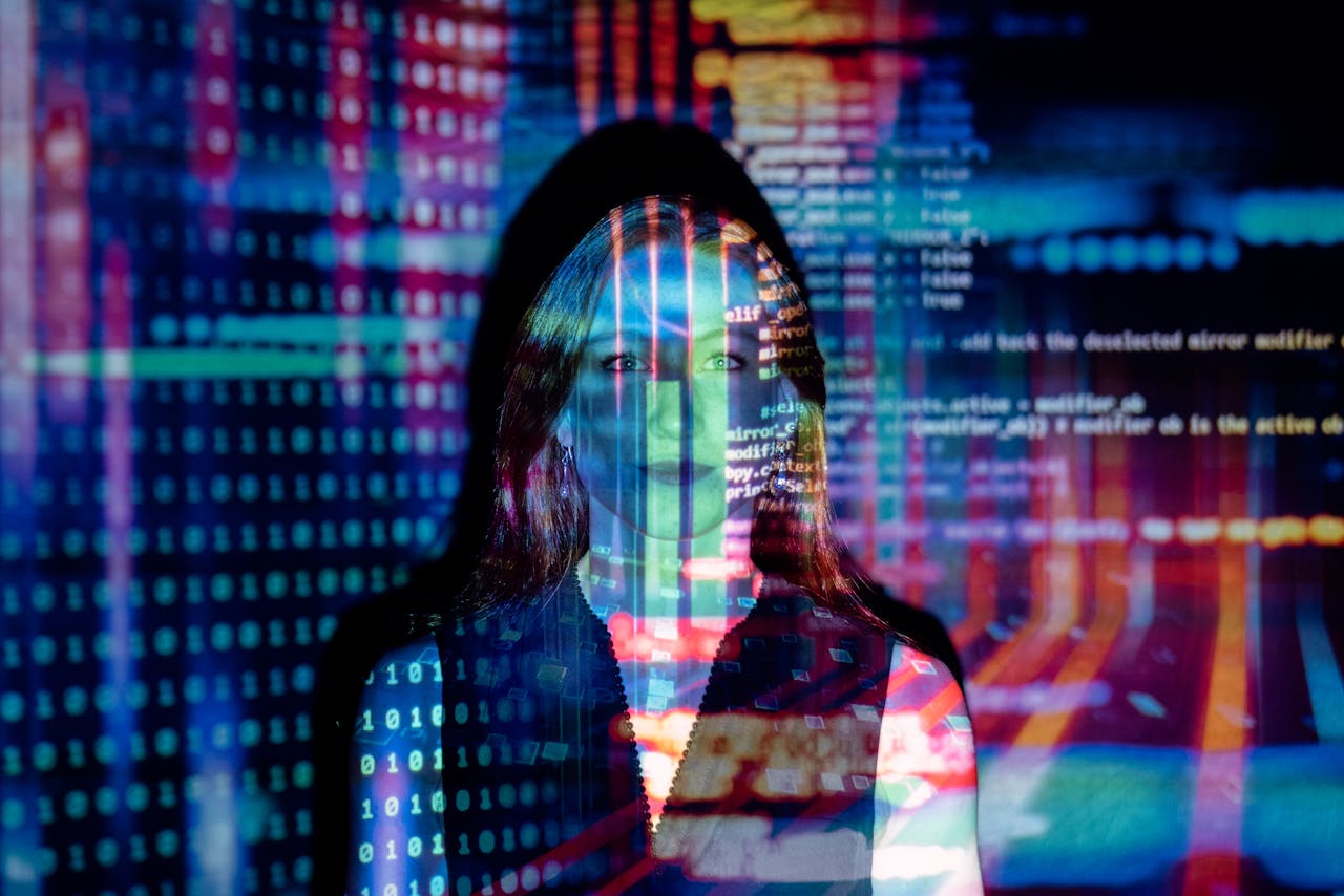 about-002 A woman with digital code projections on her face, representing technology and future concepts.