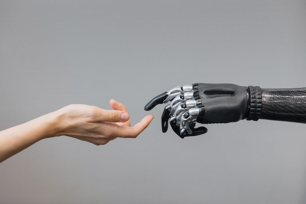 the human hand and the siber hand bionic prosthesis make a handshake and greeting. modern technologies of prosthetics the human hand and the siber hand bionic prosthesis make a handshake and greeting. modern technologies of prosthetics